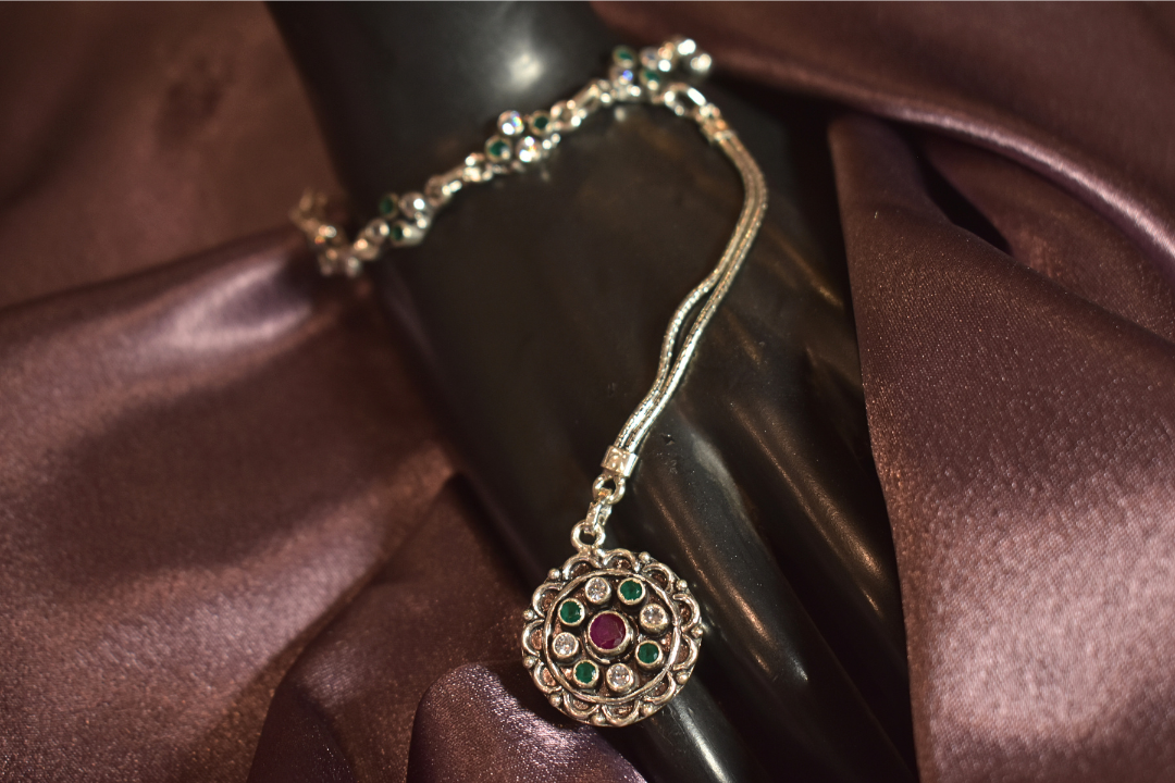 Regal Silver Hand Ornament with Emerald Accents
