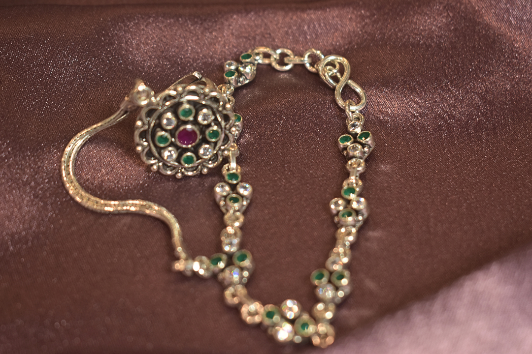 Regal Silver Hand Ornament with Emerald Accents