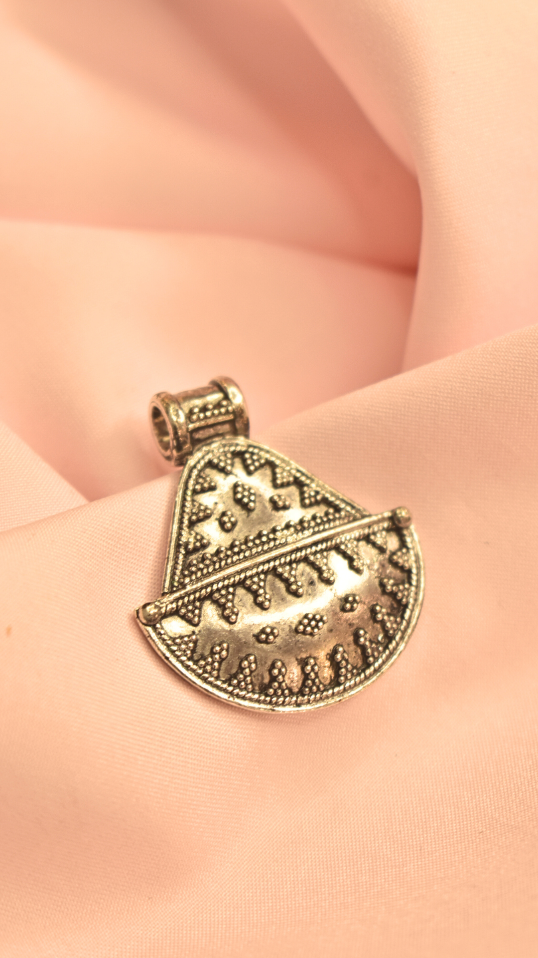 Traditional Silver Pendant with Geometric Patterns and Beaded Detailing