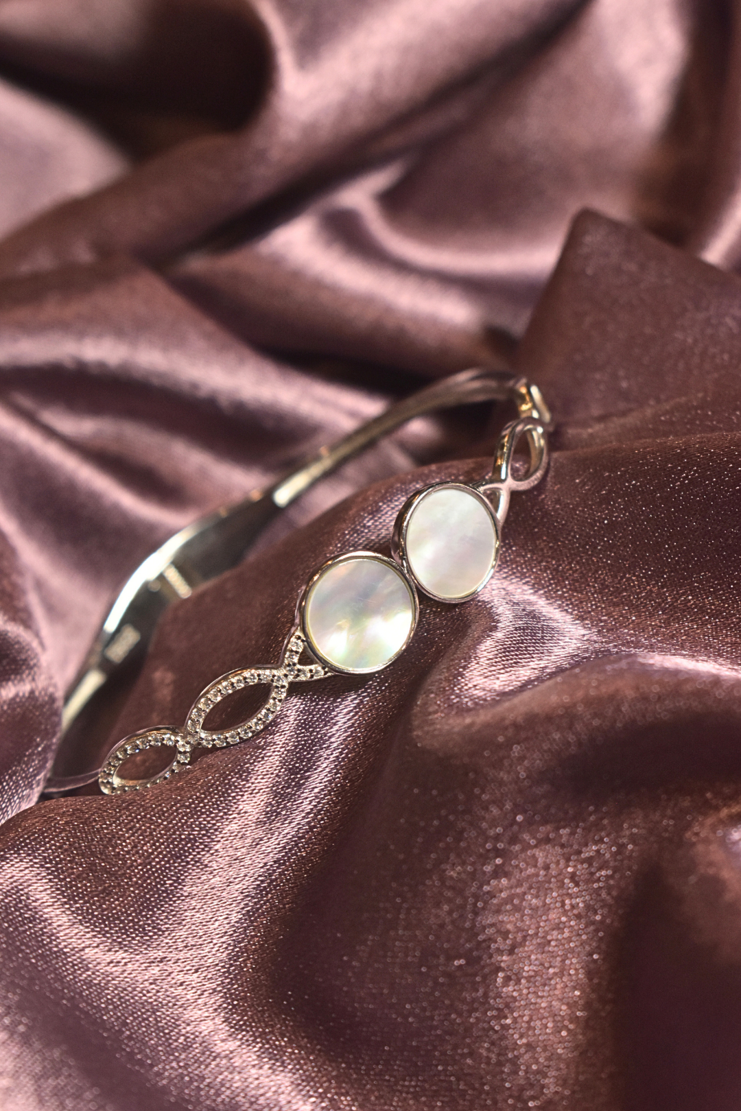 Lustrous Pearl Accent Bracelet with Infinity Crystal Design