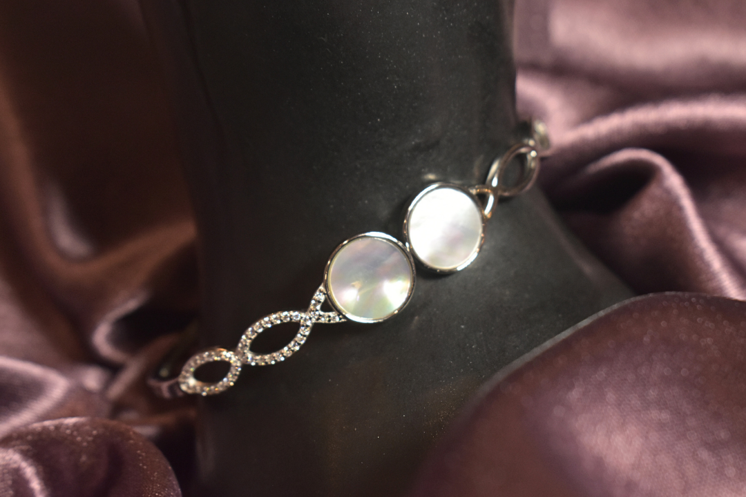 Lustrous Pearl Accent Bracelet with Infinity Crystal Design