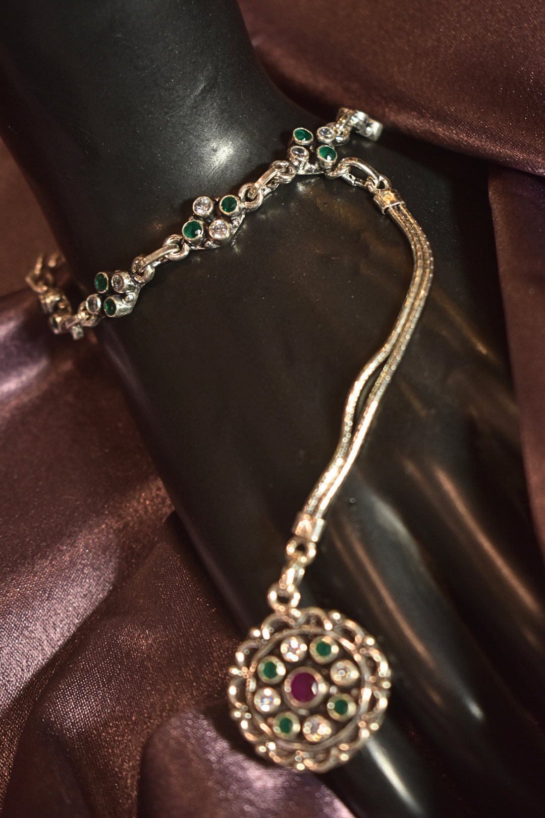 Regal Silver Hand Ornament with Emerald Accents