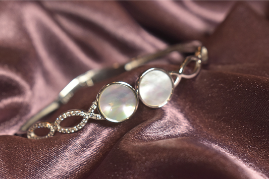 Lustrous Pearl Accent Bracelet with Infinity Crystal Design